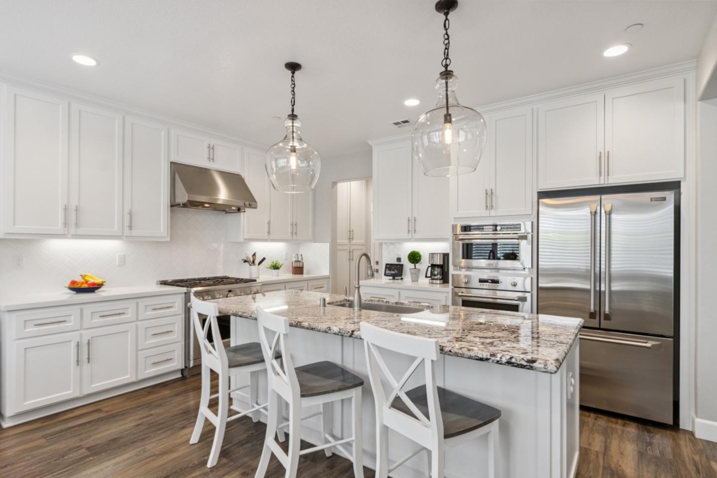 2610 Lighthouse Lane Marina, CA 93933 - Photo 12 of 43 a kitchen with granite countertop a center island and stainless steel appliances