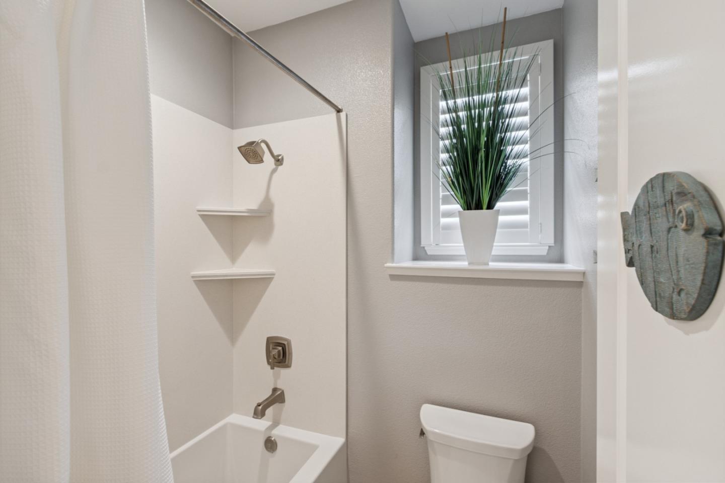 2610 Lighthouse Lane Marina, CA 93933 - Photo 21 of 43 a bathroom with a sink a toilet and a mirror