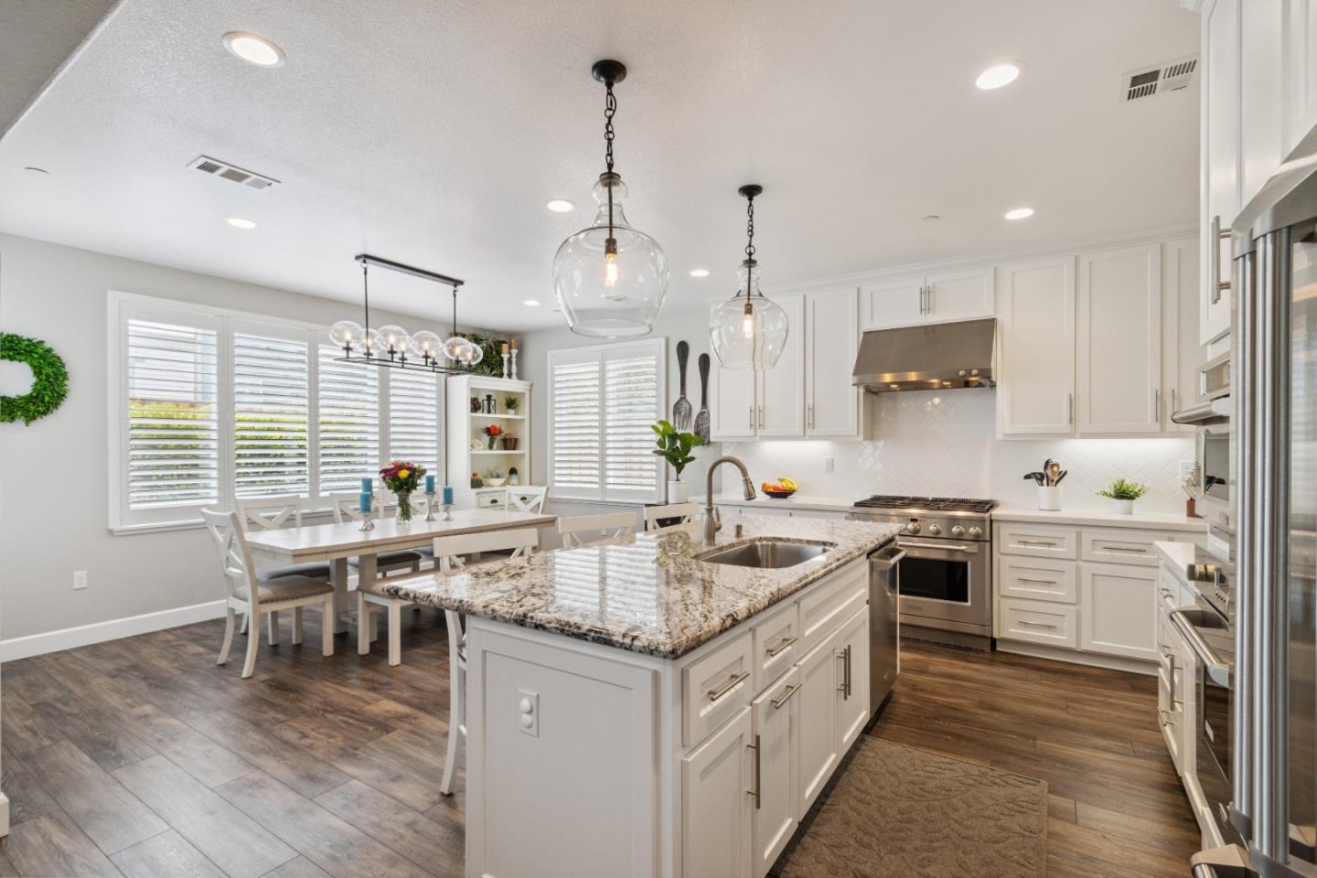 2610 Lighthouse Lane Marina, CA 93933 - Photo 10 of 43 a kitchen with stainless steel appliances granite countertop a stove and a wooden floors