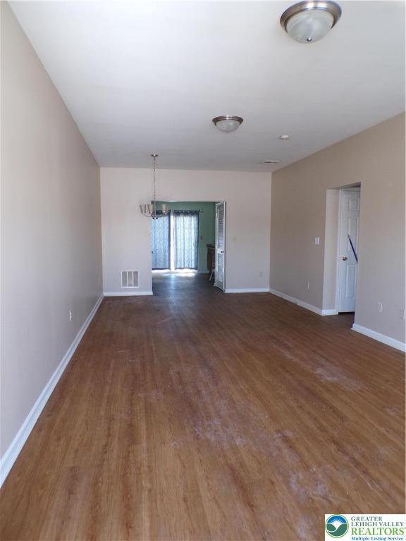 2022 Mercer Way Easton, PA 18040 - Photo 2 of 13 an empty room with wooden floor and windows