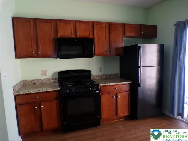 a kitchen with a refrigerator and a microwave