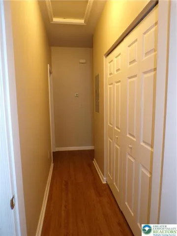 a view of a hallway with wooden floor