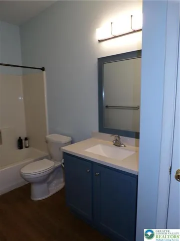 a bathroom with a sink toilet and mirror