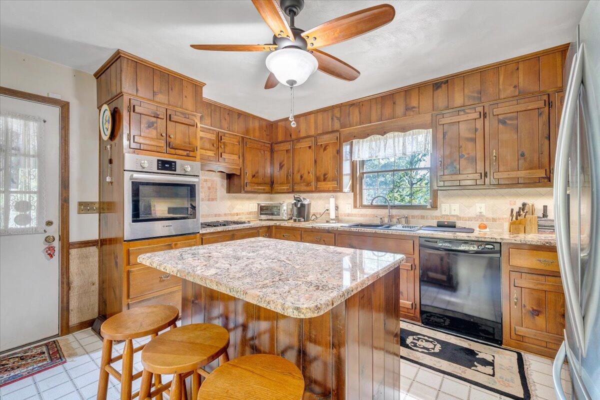 3737 Bore Auger Road Blue Ridge, VA 24064 - Photo 12 of 100 a kitchen with a stove a sink and a refrigerator
