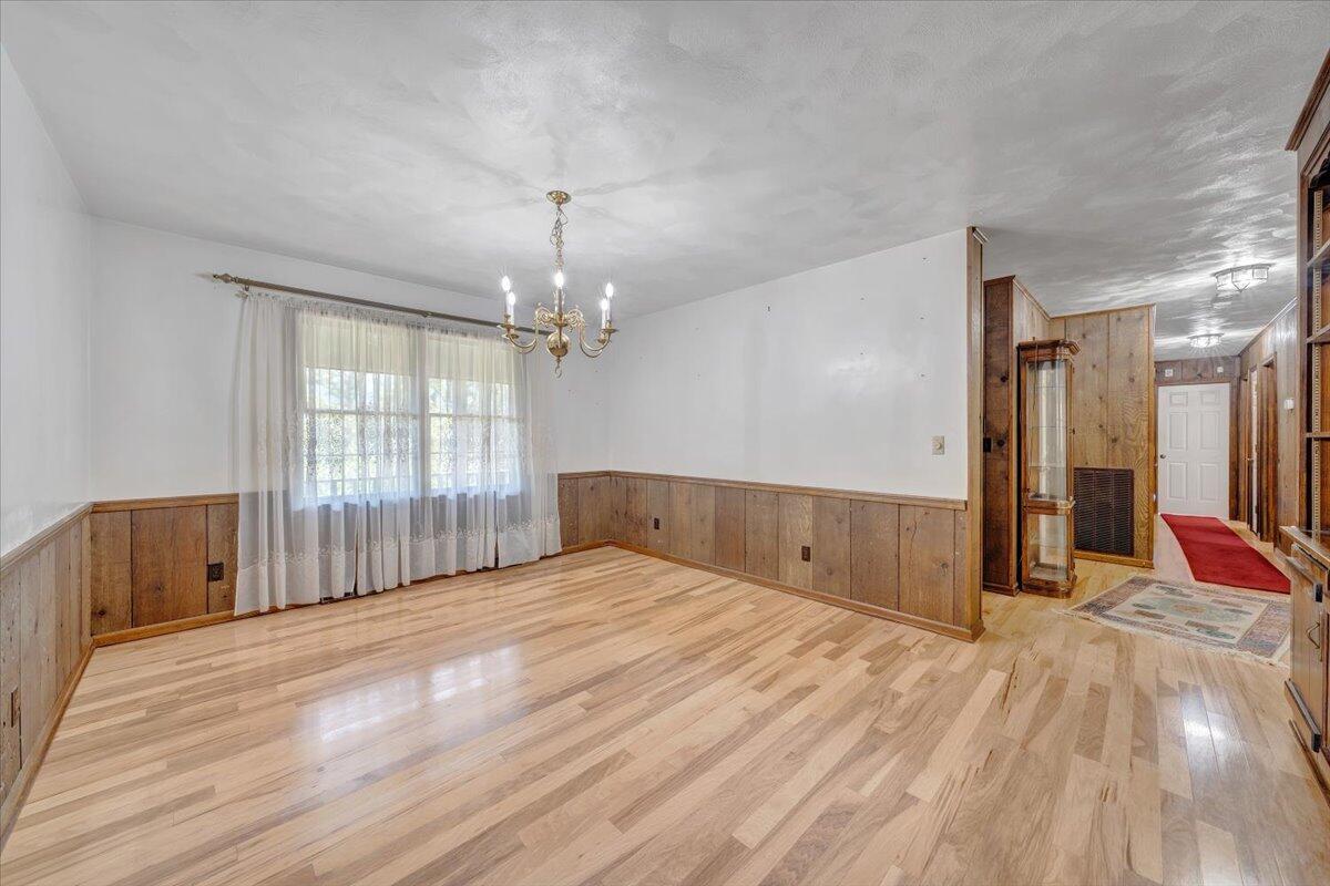 3737 Bore Auger Road Blue Ridge, VA 24064 - Photo 29 of 100 a view of an empty room with wooden floor and a window