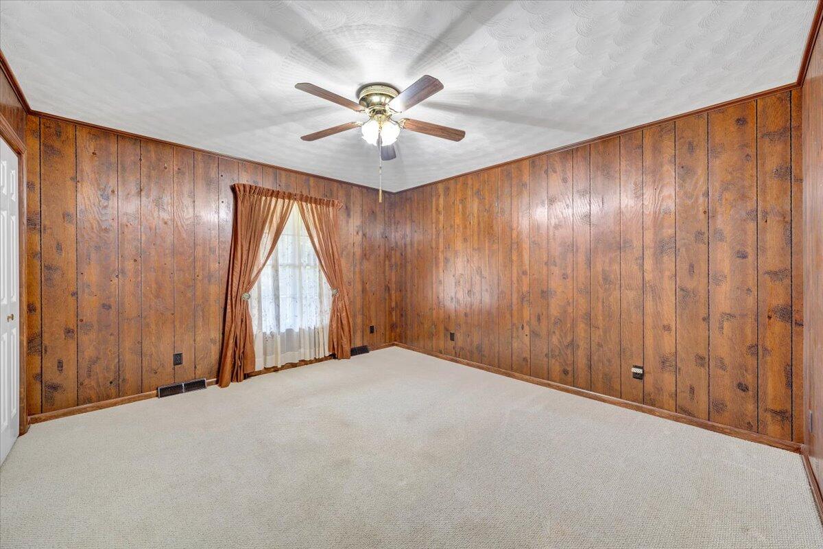 3737 Bore Auger Road Blue Ridge, VA 24064 - Photo 35 of 100 an empty room with windows and fan chandelier
