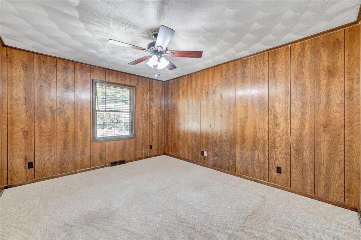 3737 Bore Auger Road Blue Ridge, VA 24064 - Photo 37 of 100 an empty room with windows and fan chandelier fan