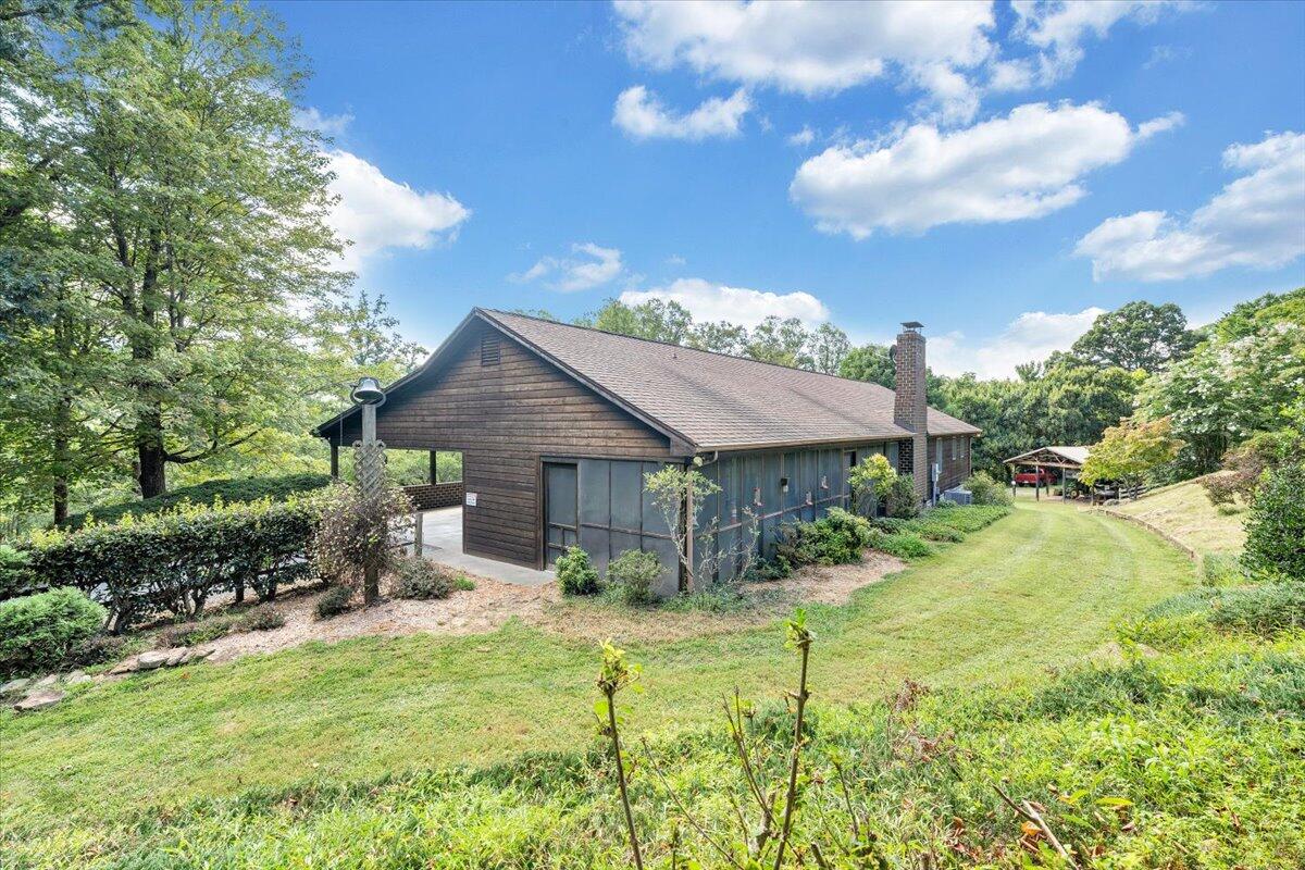 3737 Bore Auger Road Blue Ridge, VA 24064 - Photo 70 of 100 a backyard of a house with yard and outdoor seating