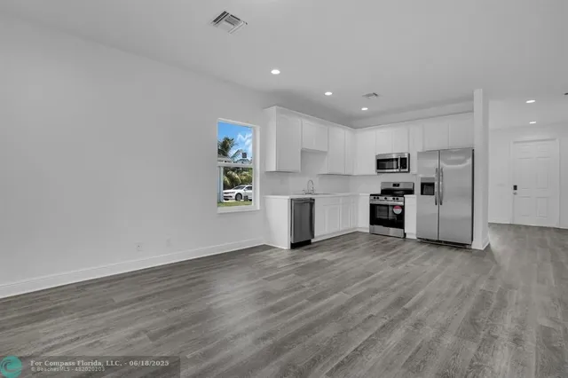 a view of kitchen with wooden floor