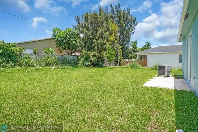 a view of a house with a yard and a garden