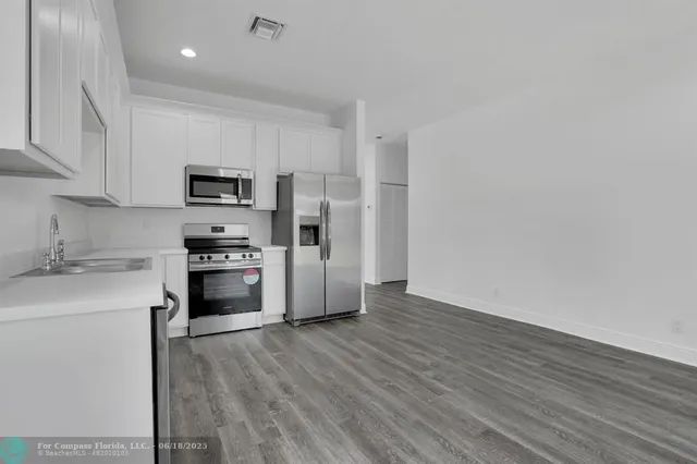 a kitchen with wooden cabinets and stainless steel appliances