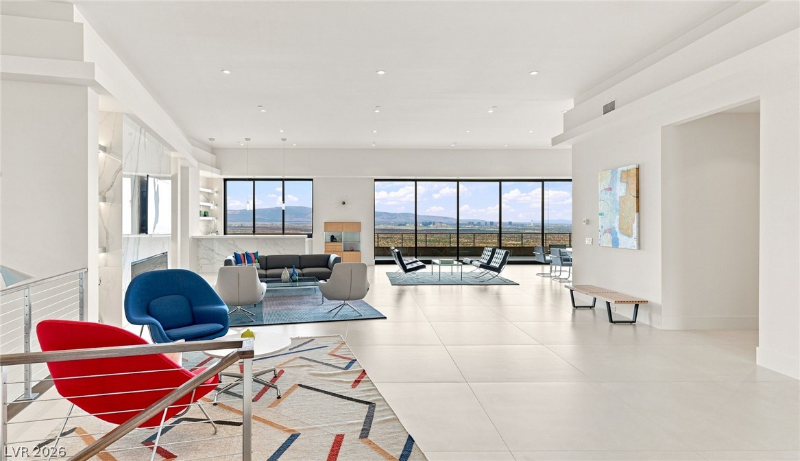 677 Overlook Rim Drive Henderson, NV 89012 - Photo 5 of 97 Floor-to-ceiling glass doors open to sweeping landscape views from this grand main level.