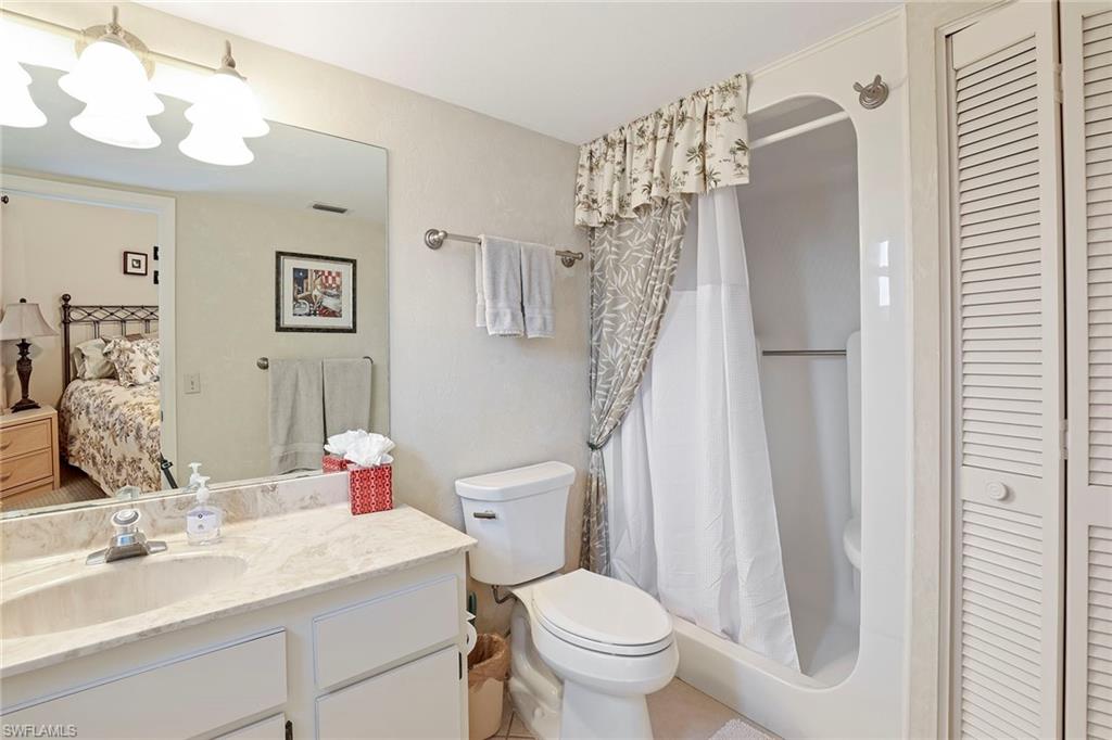 84 Georgetown Boulevard, Unit 84 Naples, FL 34112 - Photo 11 of 17 a bathroom with a sink toilet and shower
