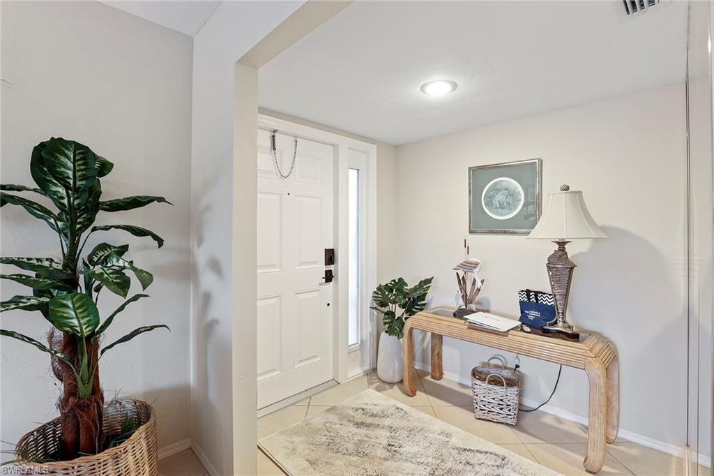 84 Georgetown Boulevard, Unit 84 Naples, FL 34112 - Photo 14 of 17 a living room with furniture and a potted plant