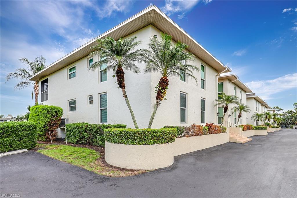 84 Georgetown Boulevard, Unit 84 Naples, FL 34112 - Photo 16 of 17 a view of a small house with potted plants