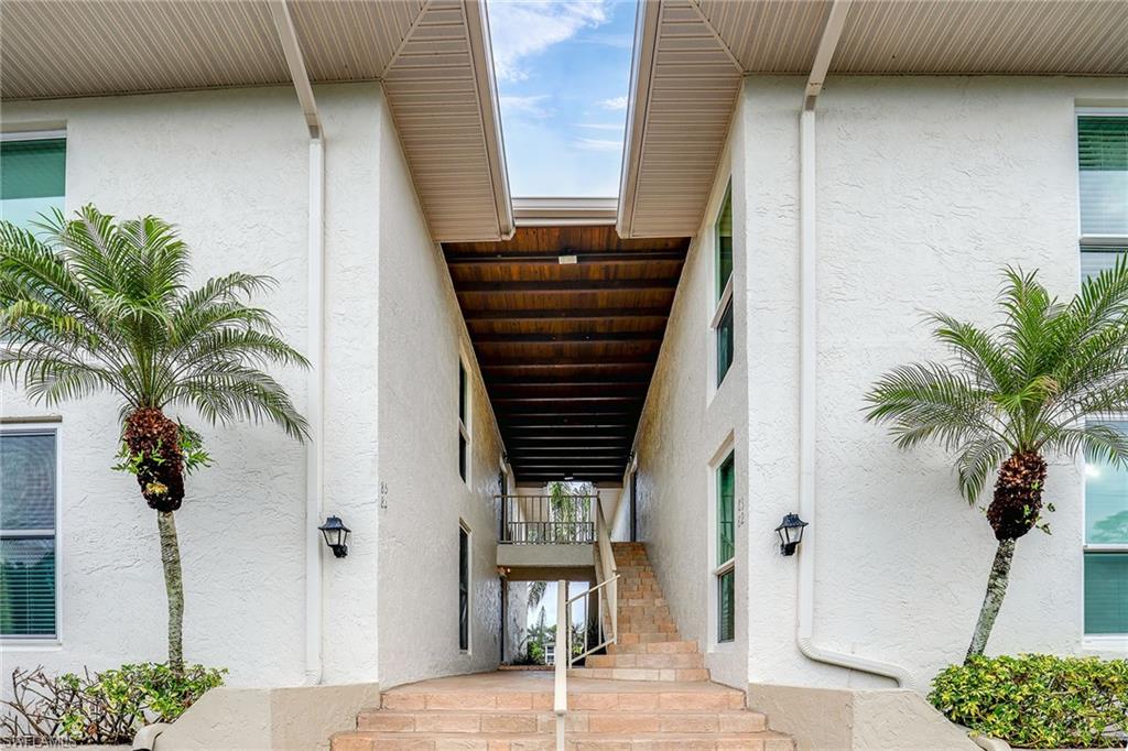 84 Georgetown Boulevard, Unit 84 Naples, FL 34112 - Photo 17 of 17 a view of potted plants in front of door