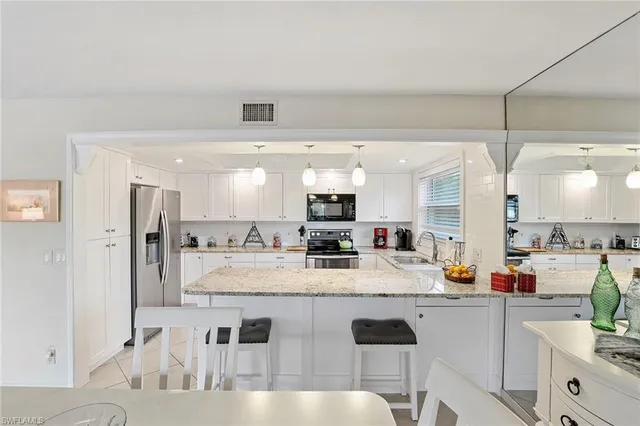 a kitchen with stainless steel appliances granite countertop a sink counter space and cabinets