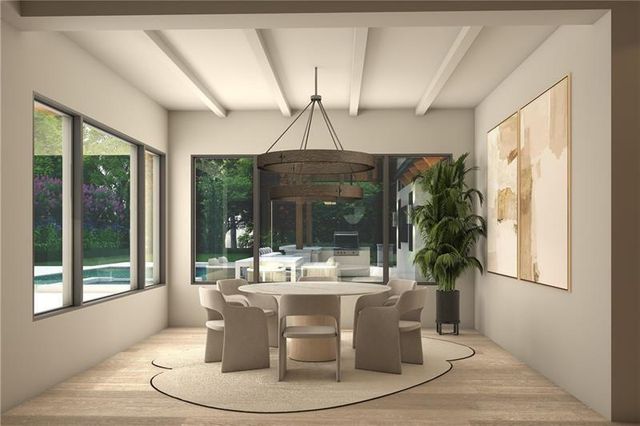 a dining room with glass top table and chairs