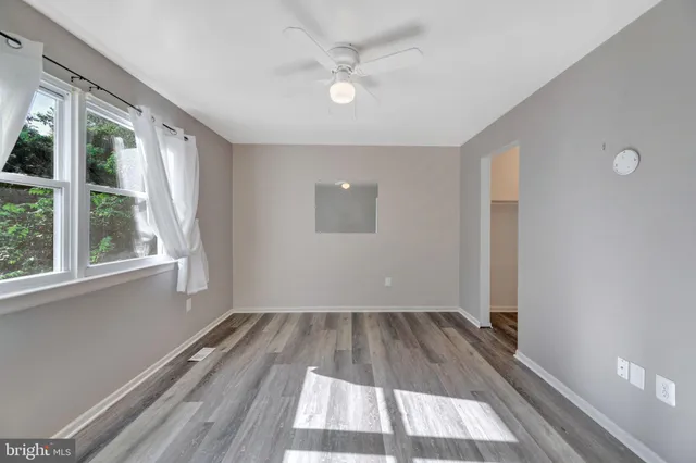 wooden floor in an empty room with a window