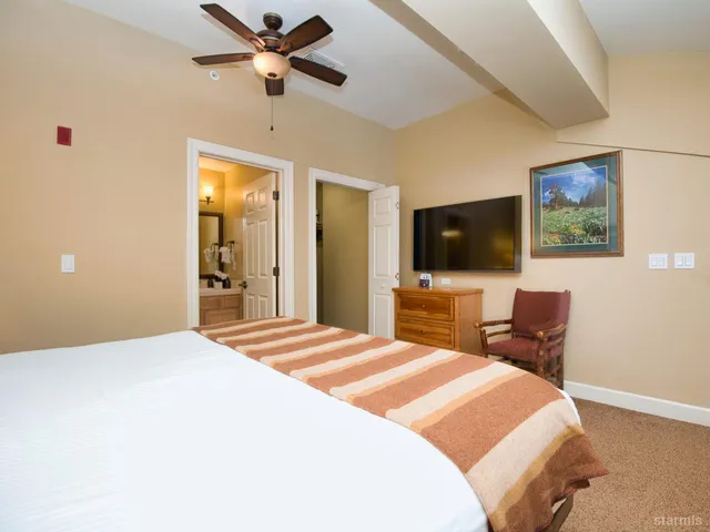 a bedroom with a bed and a flat screen tv