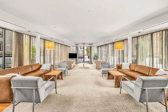 a living room with furniture and large windows