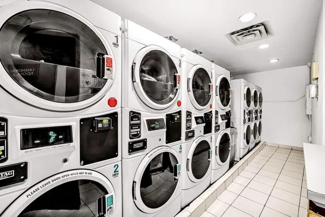 a view of washer and dryer with kitchen in the background