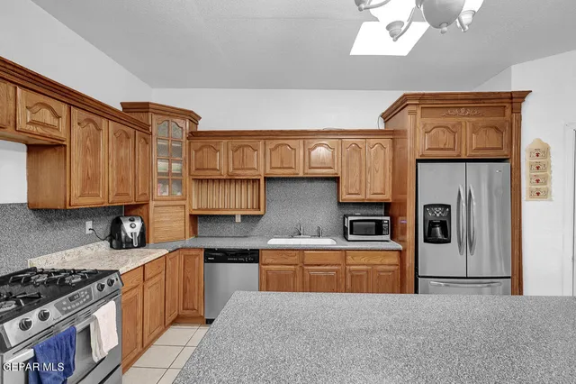 a bathroom with a granite countertop sink and mirror