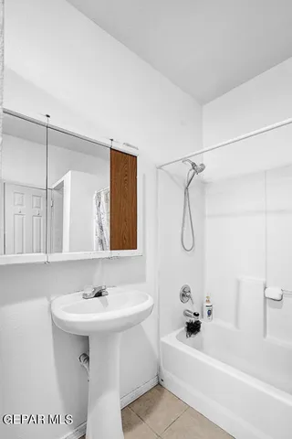 a bedroom with a bed and a dresser in it