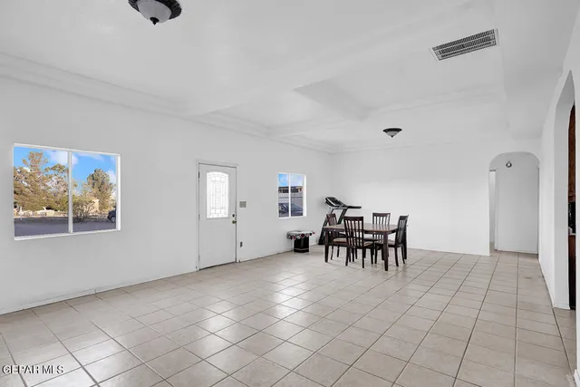 a dining room with furniture and a chandelier
