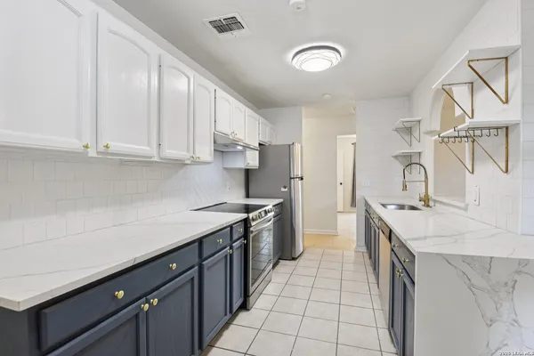 a kitchen with a sink stove and cabinets