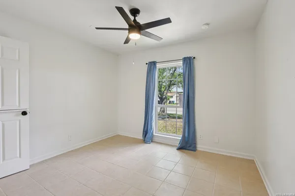 an empty room with closet and windows
