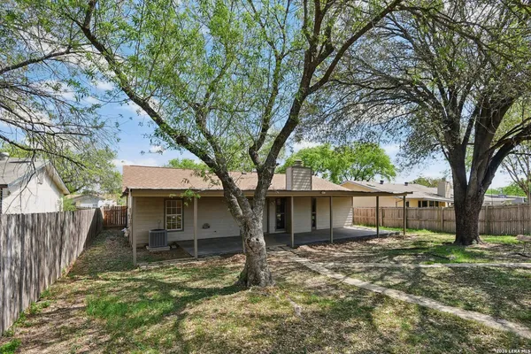 a house that has a tree in front of it