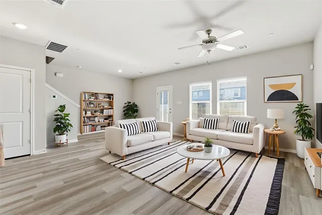 a living room with furniture and wooden floor