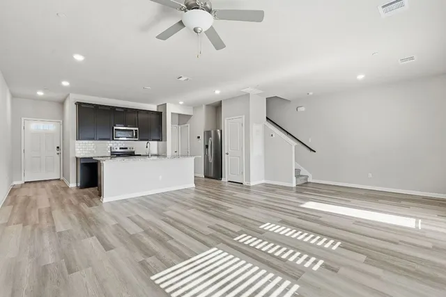 a view of kitchen with cabinets and wooden floor