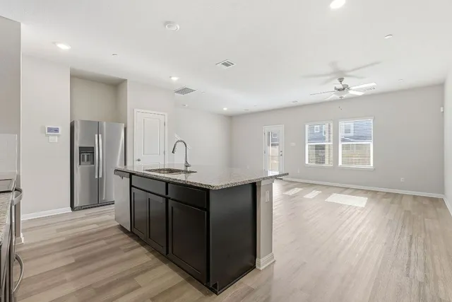a view of a patio with table and chairs with wooden floor and fence
