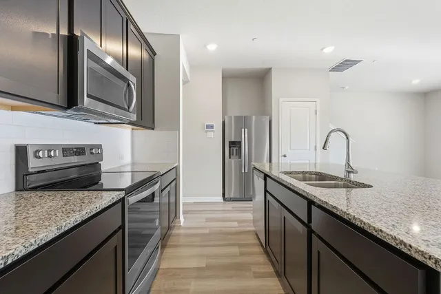a kitchen with a stove microwave and refrigerator