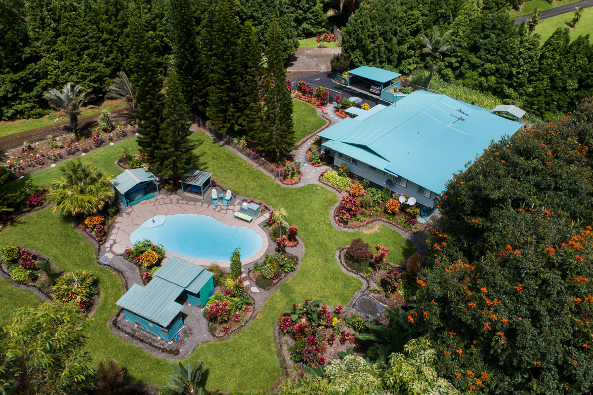 an aerial view of a house a yard and swimming pool