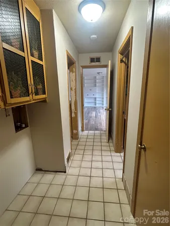 a view of an empty room and a bathroom
