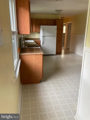 a kitchen with a sink and a refrigerator