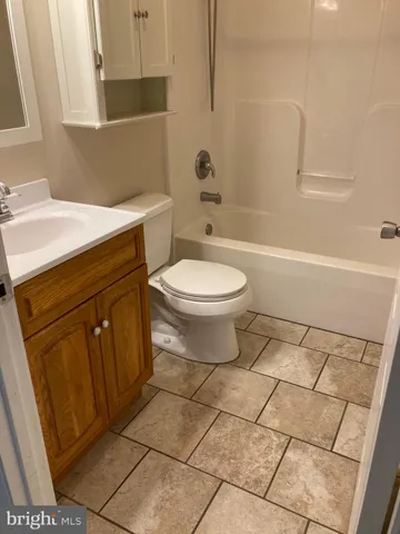 a bathroom with a toilet a sink and bathtub