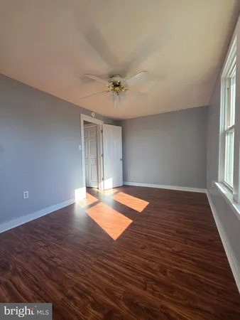 a view of wooden floor and windows in a room