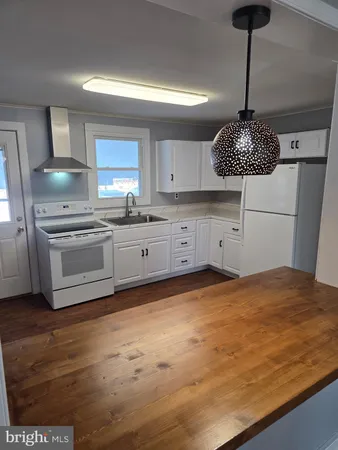 a kitchen with a stove top oven sink and cabinets