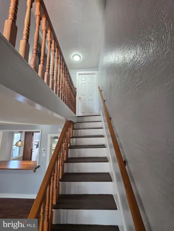 a kitchen that has a lot of cabinets in it and wooden floors