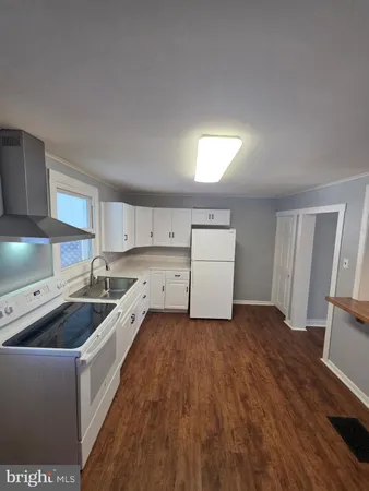 a view of kitchen with granite countertop window and chandelier