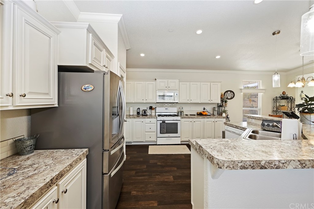 23161 Forrest Road Perris, CA 92570 - Photo 14 of 43 a kitchen with granite countertop a refrigerator stove top oven and sink