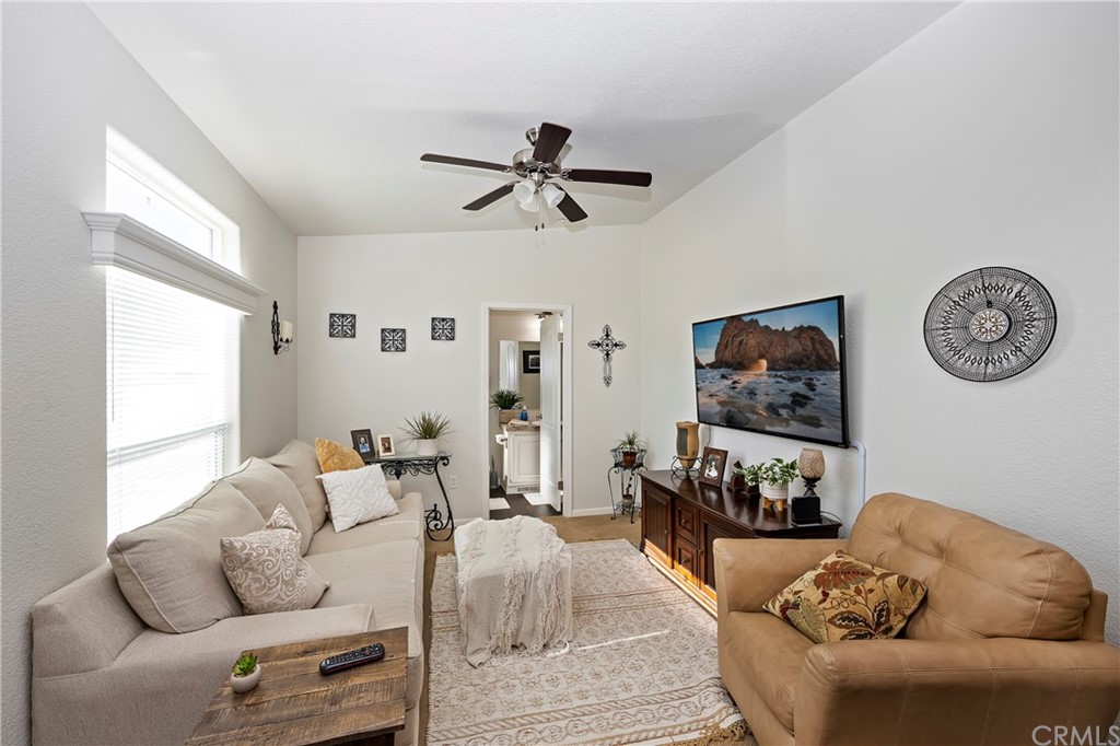 23161 Forrest Road Perris, CA 92570 - Photo 15 of 43 a living room with furniture a couch and a flat screen tv