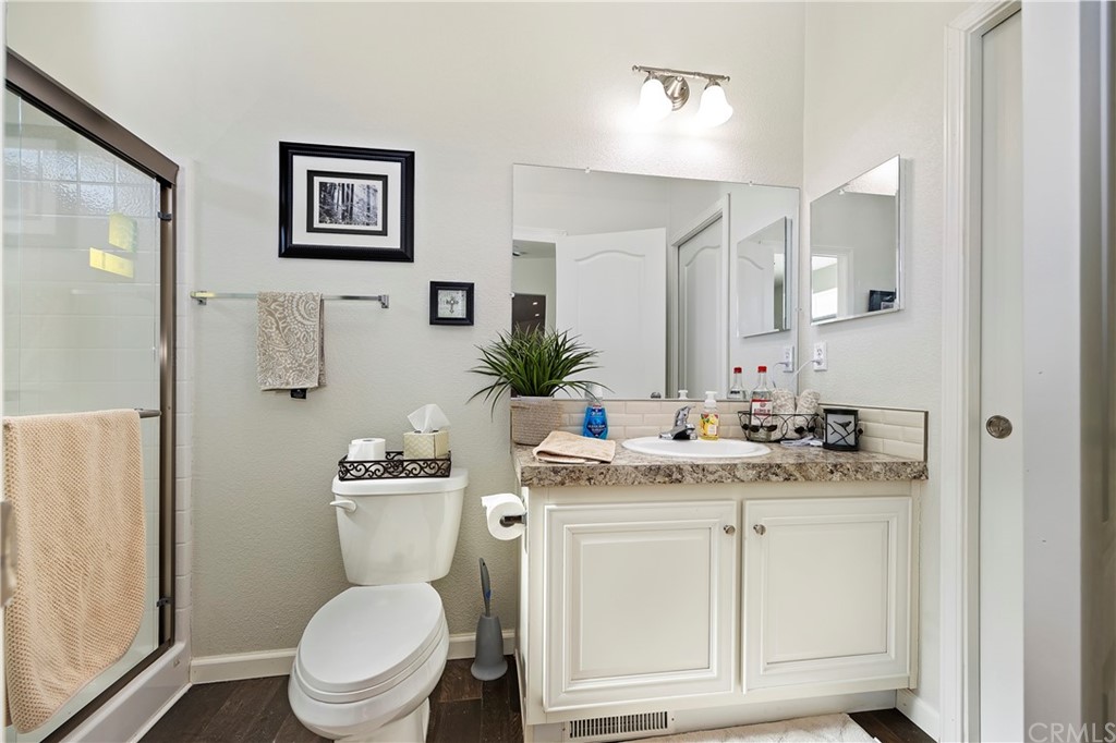 23161 Forrest Road Perris, CA 92570 - Photo 17 of 43 a bathroom with a granite countertop toilet sink and mirror