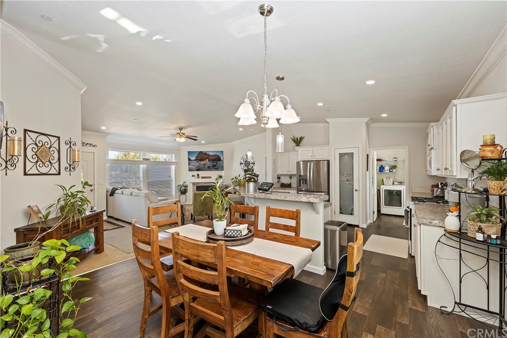 23161 Forrest Road Perris, CA 92570 - Photo 18 of 43 a view of a dining room and livingroom with furniture wooden floor a chandelier