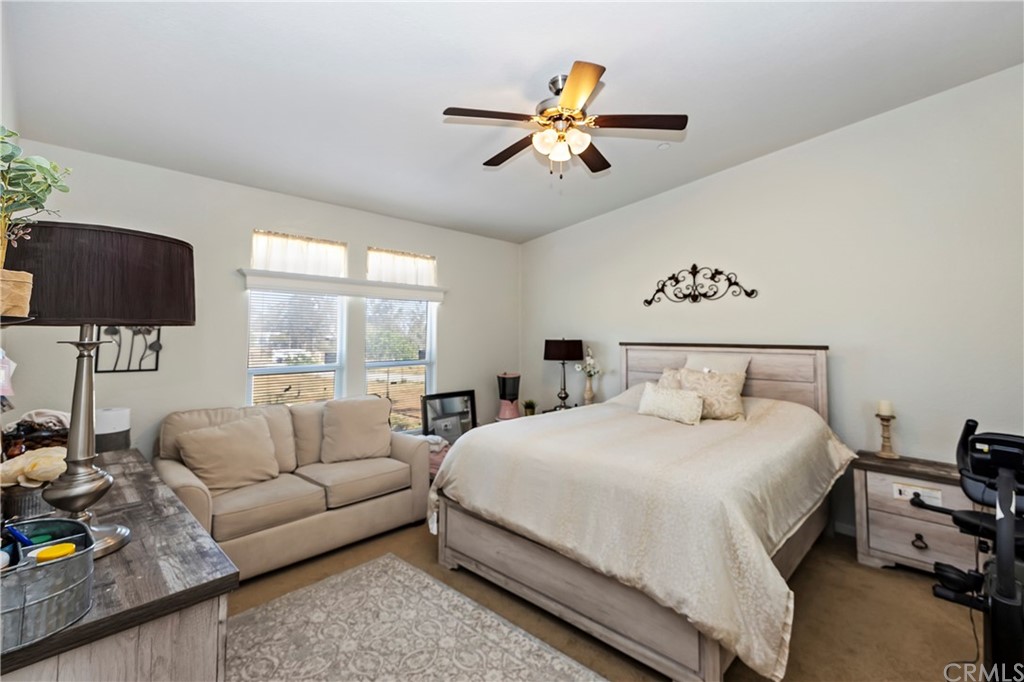 23161 Forrest Road Perris, CA 92570 - Photo 20 of 43 a bedroom with a bed a couch and a window