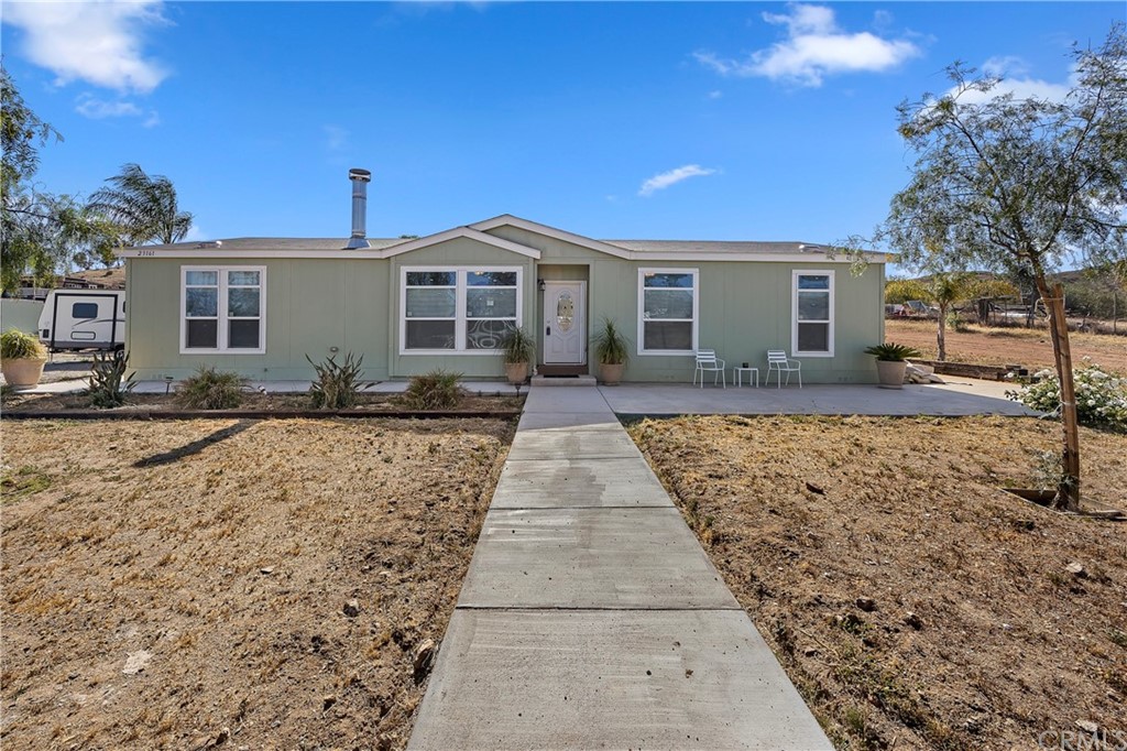 23161 Forrest Road Perris, CA 92570 - Photo 2 of 43 a front view of a house with a yard
